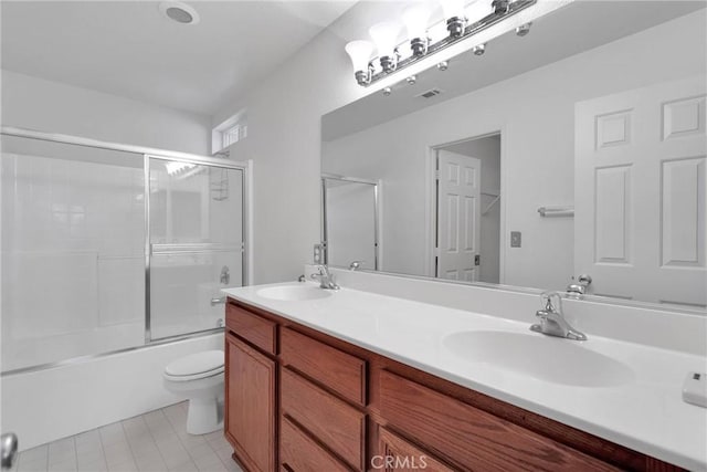 full bathroom with vanity, toilet, and bath / shower combo with glass door