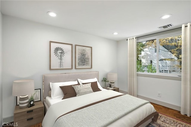 bedroom with dark hardwood / wood-style floors