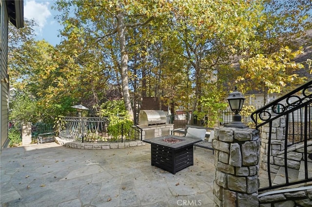 view of patio / terrace featuring a grill and a fire pit