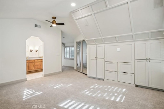 interior space with light carpet, lofted ceiling, and ceiling fan