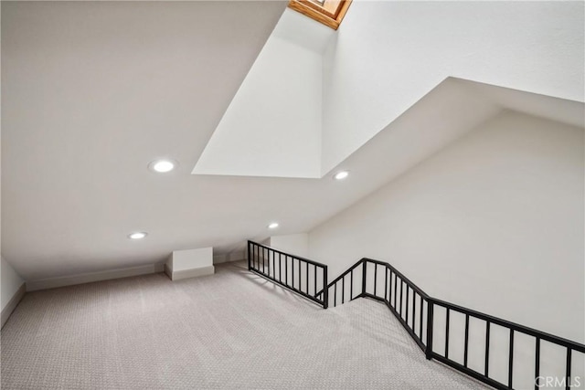 bonus room featuring a skylight and carpet flooring