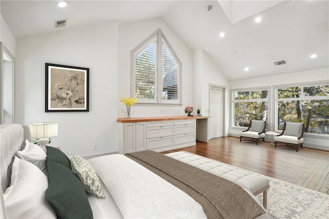 bedroom featuring dark hardwood / wood-style flooring and high vaulted ceiling