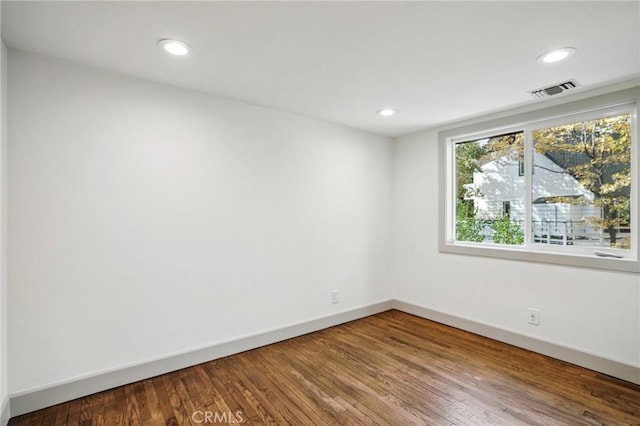 spare room with hardwood / wood-style floors