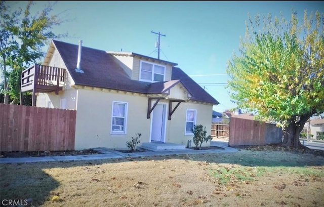 rear view of property with a lawn