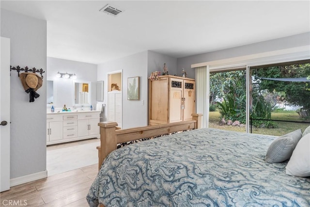 bedroom with access to exterior, ensuite bath, and light hardwood / wood-style flooring