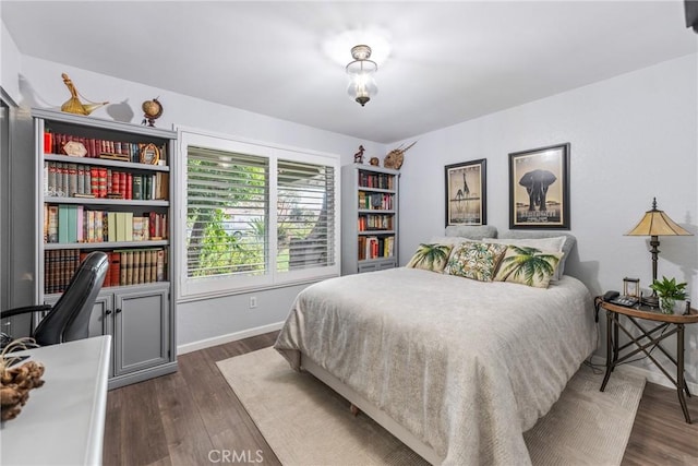 bedroom with dark hardwood / wood-style flooring