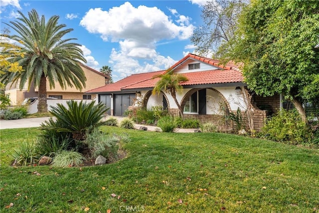 mediterranean / spanish-style house with a front yard