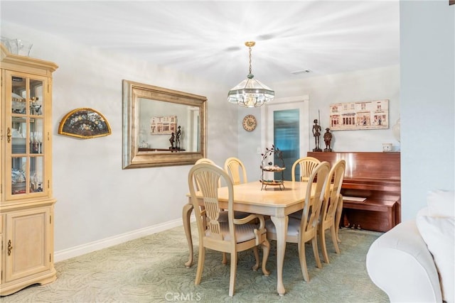 dining space with an inviting chandelier