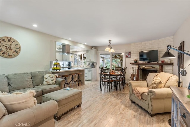 living room with sink and light hardwood / wood-style floors