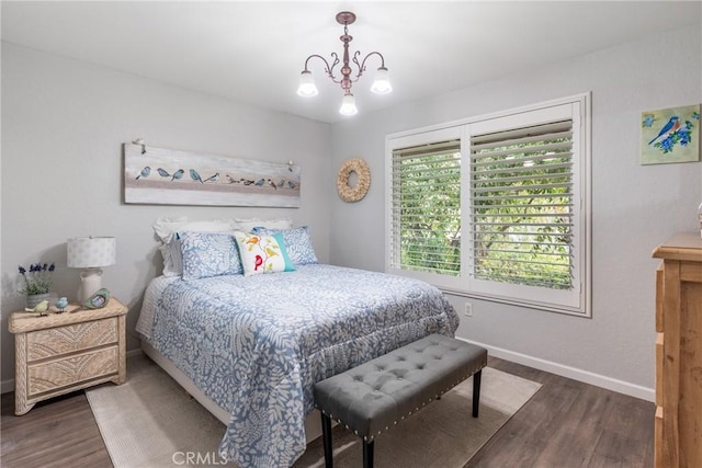 bedroom featuring an inviting chandelier and dark wood-type flooring