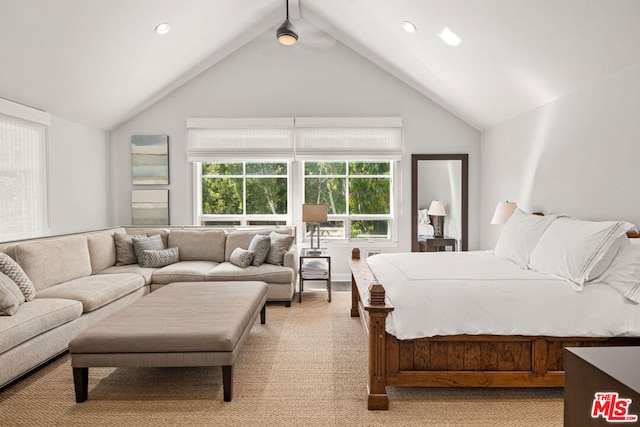 carpeted bedroom with high vaulted ceiling