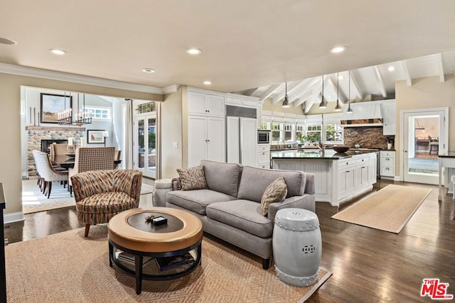 living room featuring dark hardwood / wood-style flooring, vaulted ceiling with beams, and crown molding