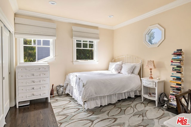 bedroom with crown molding and hardwood / wood-style flooring