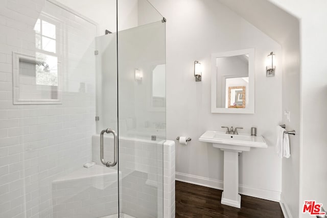 bathroom featuring hardwood / wood-style floors and an enclosed shower