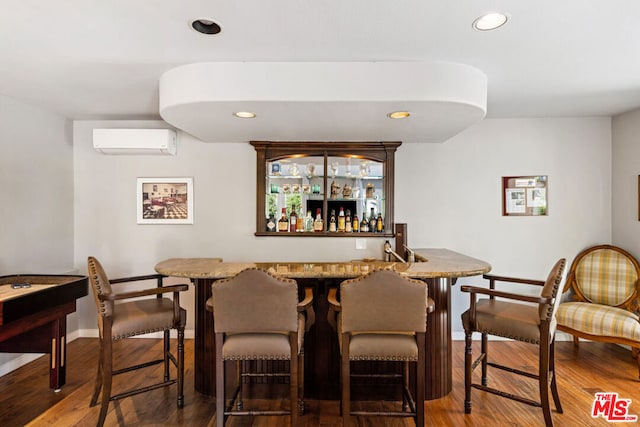 bar with dark hardwood / wood-style floors and a wall unit AC