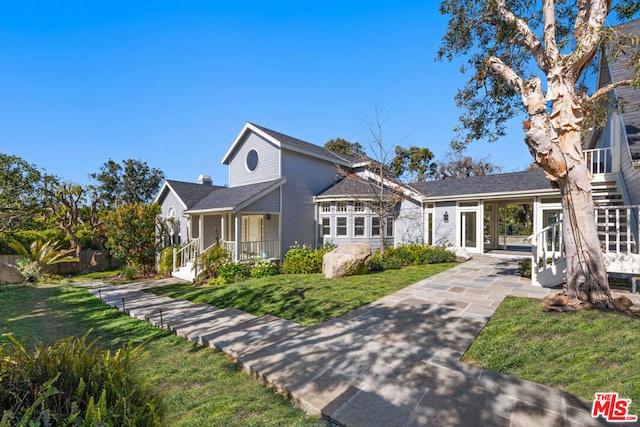 view of front of home featuring a front yard and covered porch