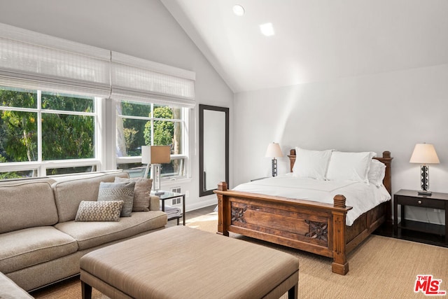 bedroom with high vaulted ceiling