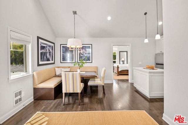 dining room featuring breakfast area, lofted ceiling, plenty of natural light, and dark hardwood / wood-style floors