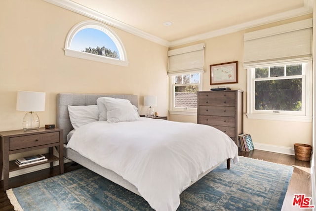 bedroom with dark hardwood / wood-style flooring and ornamental molding