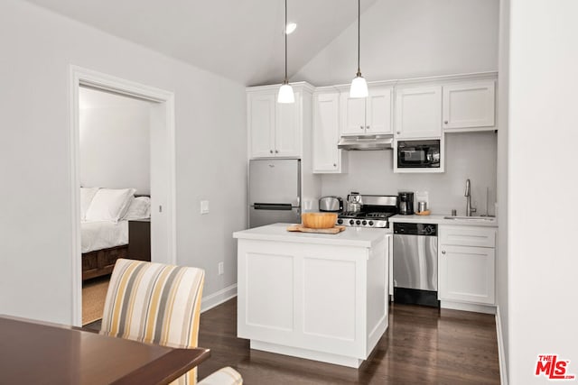 kitchen featuring pendant lighting, appliances with stainless steel finishes, sink, and white cabinets