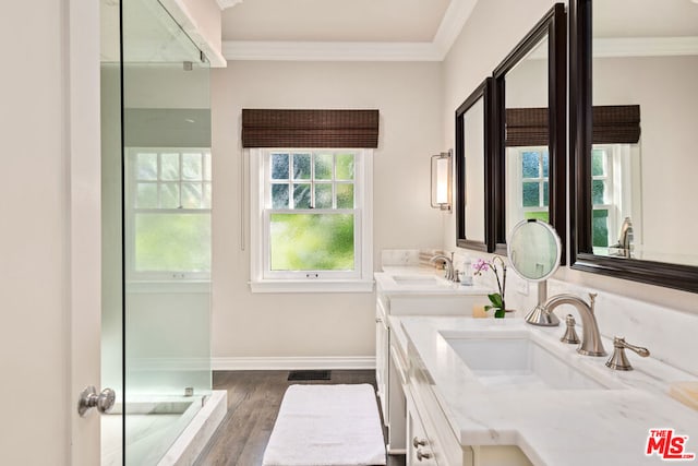 bathroom featuring hardwood / wood-style flooring, crown molding, a shower, and vanity