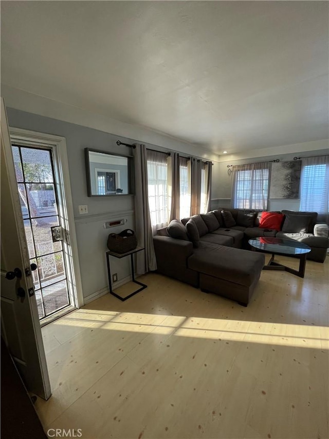 living room with a wealth of natural light and light wood-type flooring