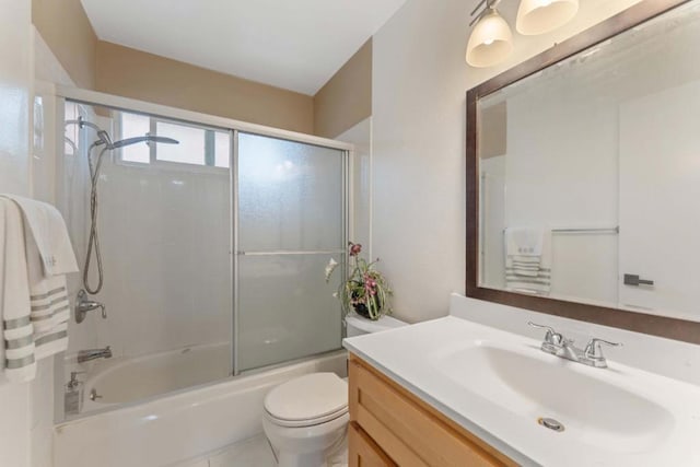 full bathroom with enclosed tub / shower combo, vanity, tile patterned flooring, and toilet