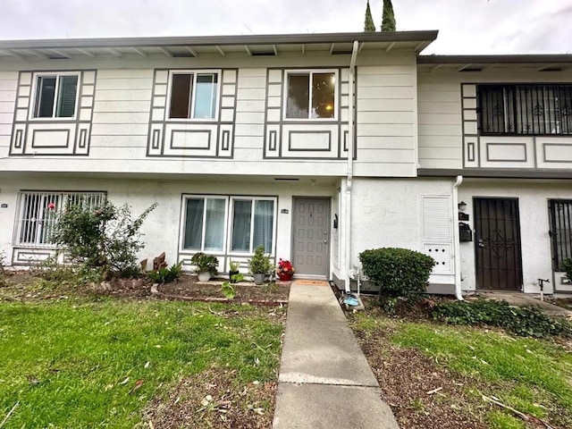 view of property featuring a front yard