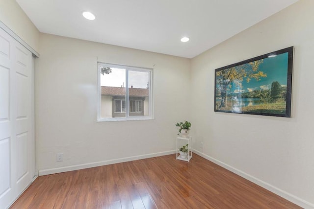 spare room with wood-type flooring