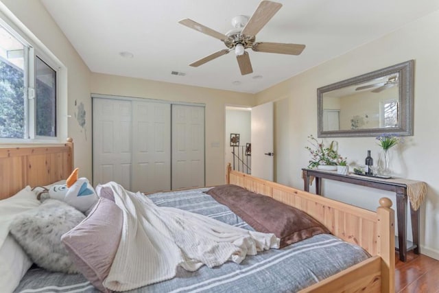 bedroom featuring hardwood / wood-style flooring, a closet, and ceiling fan