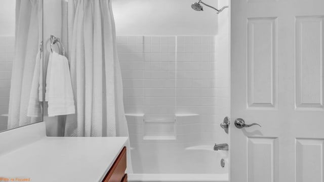 bathroom featuring vanity and shower / bath combination with curtain