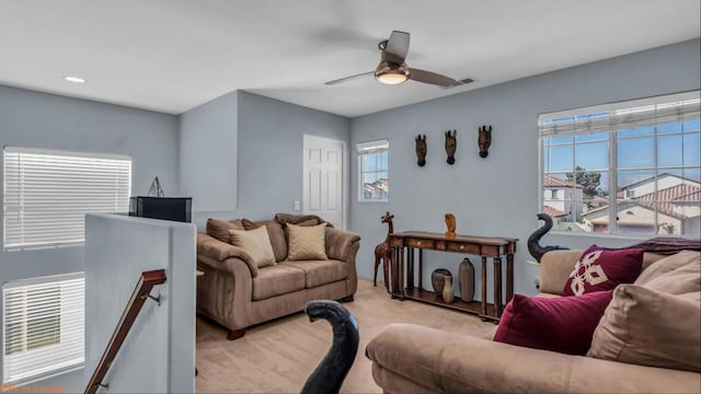 living room featuring light carpet and ceiling fan