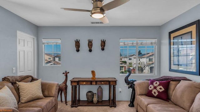 living room with light carpet and ceiling fan