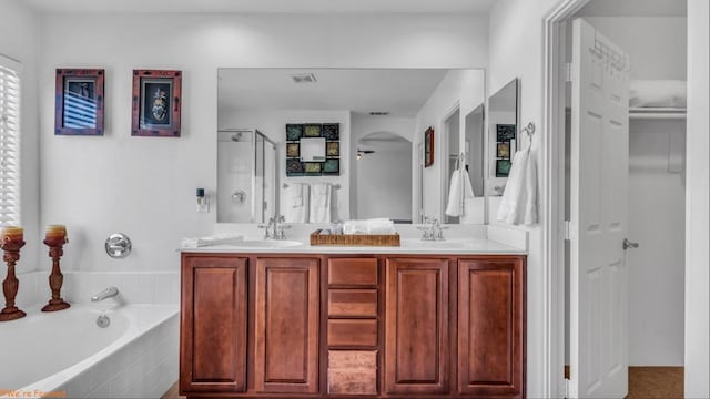 bathroom featuring vanity and shower with separate bathtub