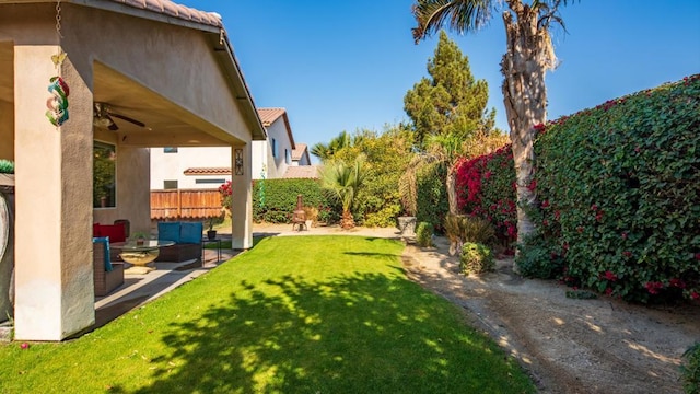 view of yard with an outdoor hangout area, ceiling fan, and a patio area