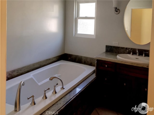 bathroom featuring vanity and a tub