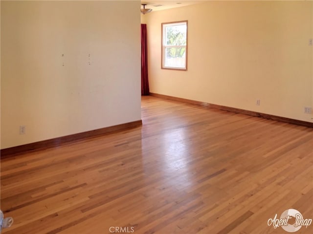 spare room with light hardwood / wood-style flooring