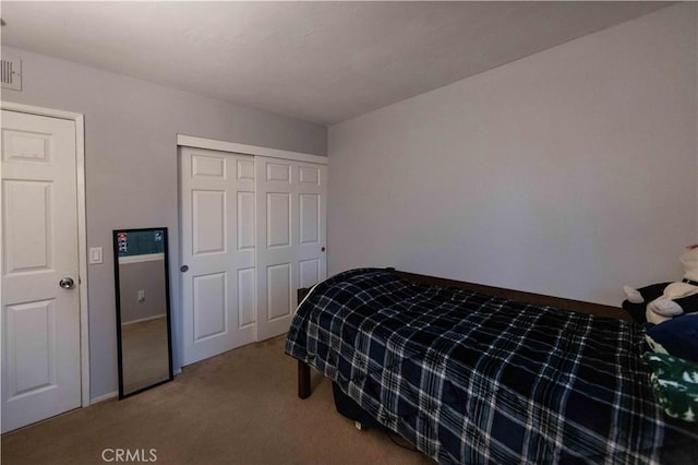 carpeted bedroom featuring a closet