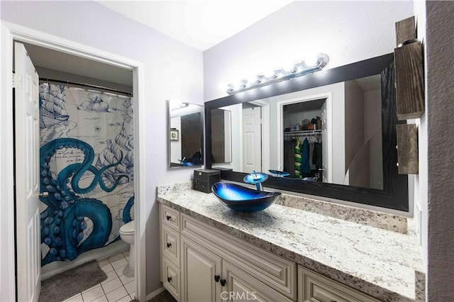 bathroom featuring vanity, tile patterned floors, and toilet