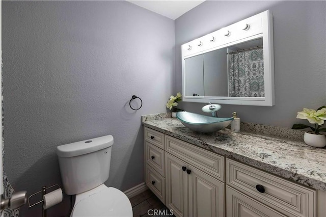 bathroom featuring vanity and toilet