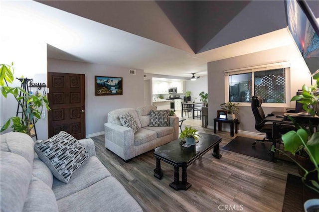 living room with lofted ceiling and dark hardwood / wood-style flooring