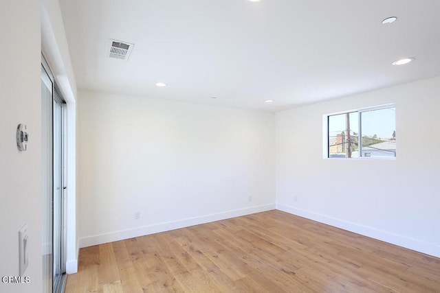 unfurnished room with light hardwood / wood-style flooring