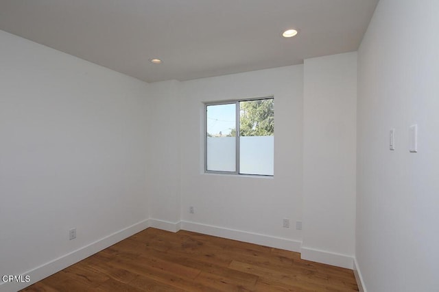 spare room with wood-type flooring