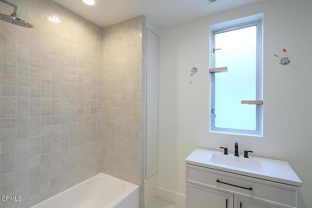 bathroom featuring vanity and tiled shower / bath combo