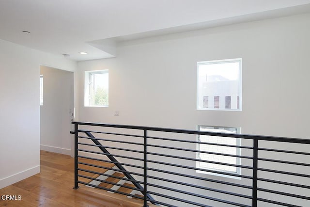 corridor with hardwood / wood-style floors