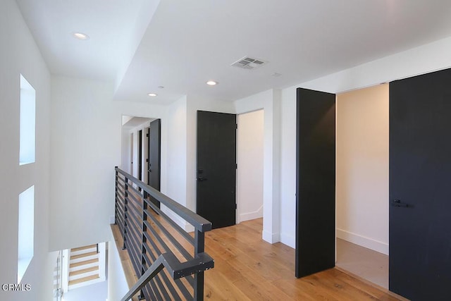 corridor with light wood-type flooring