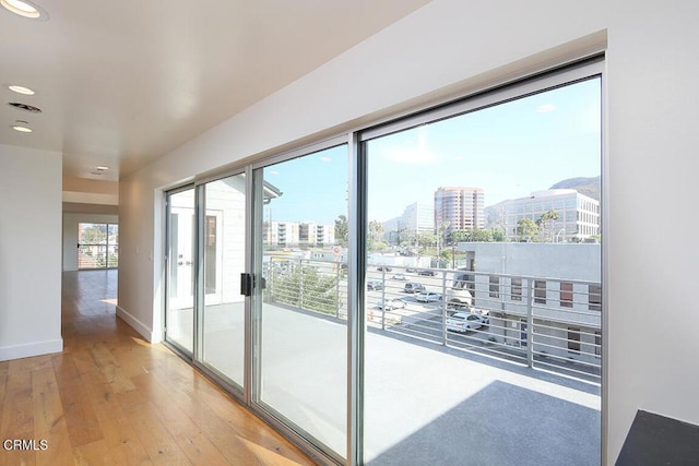 doorway with light hardwood / wood-style flooring