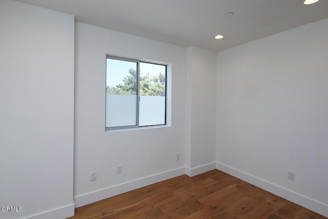 spare room featuring dark hardwood / wood-style floors