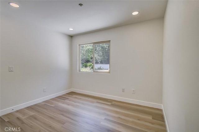 spare room with light wood-type flooring