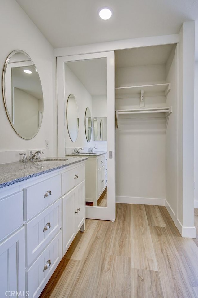 bathroom with vanity and wood-type flooring